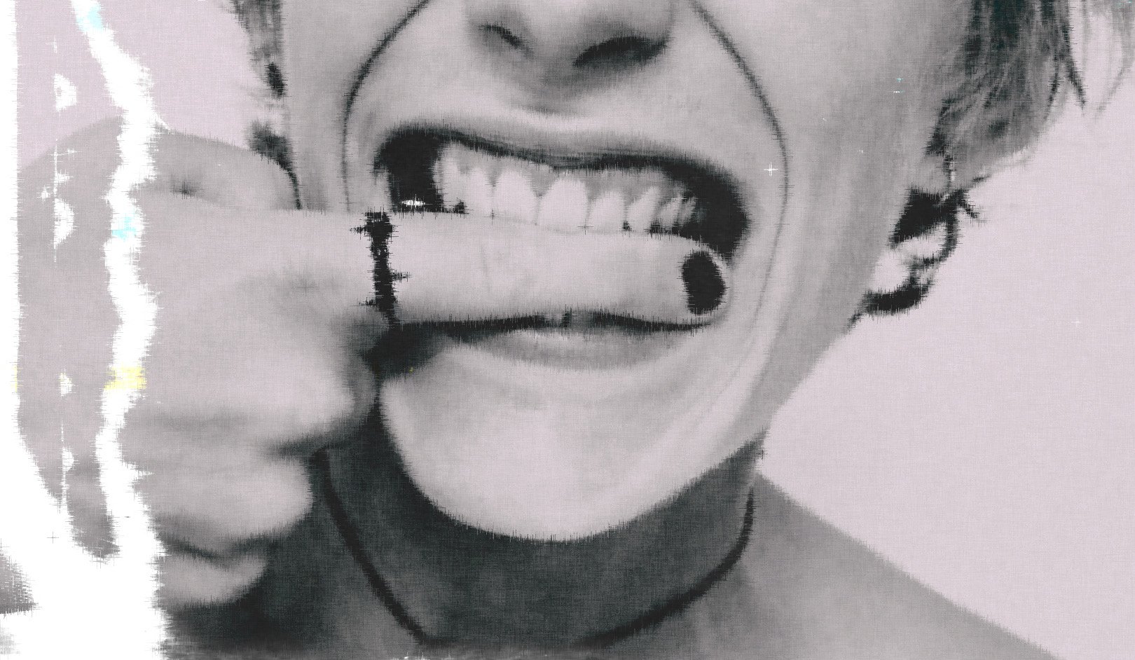 A person with short hair smiling with their mouth open, showing teeth, and holding a cigarette in their hand near their mouth, wearing a choker necklace.