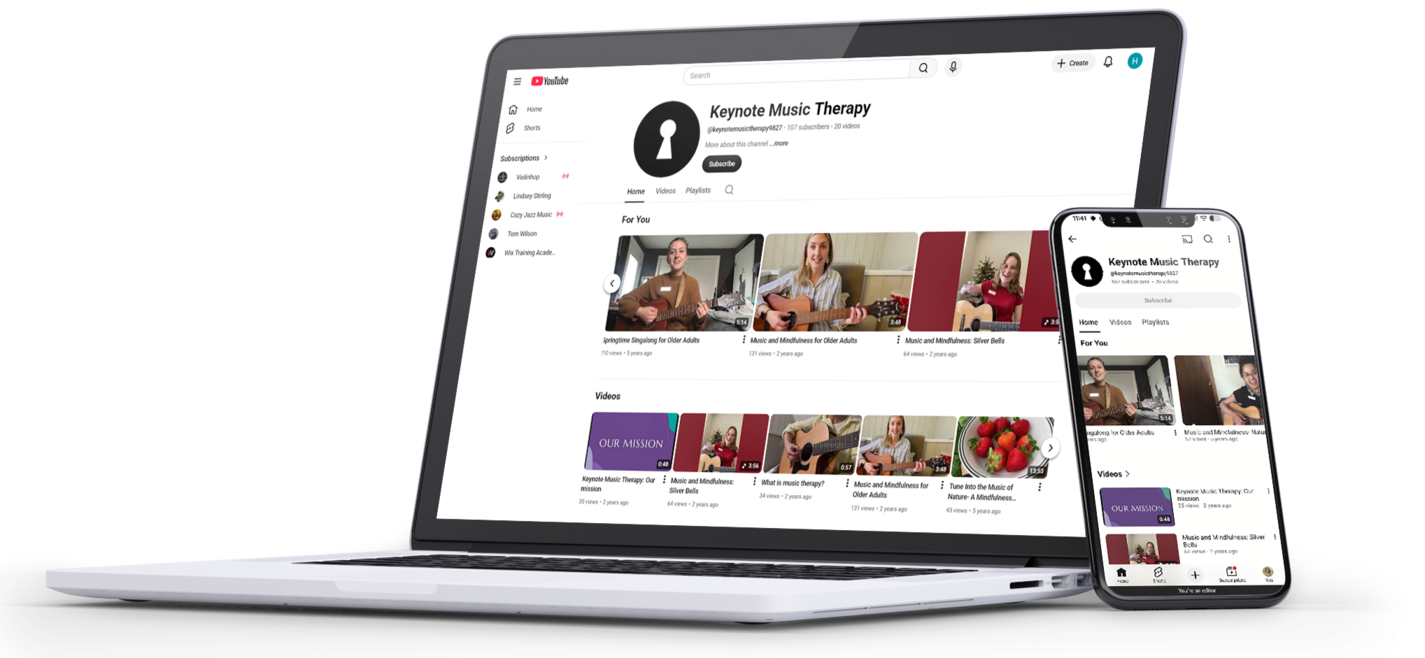 Laptop and smartphone displaying the YouTube channel 'Keynote Music Therapy' on screens, featuring videos of older adults playing guitar and singing.