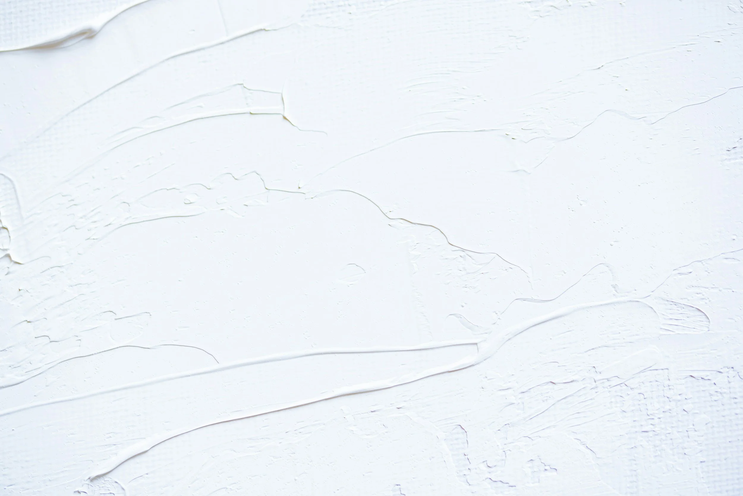 Surface blanche avec des textures de peinture en relief et craquelures.