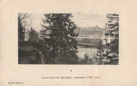 PC051  Suspension Bridge, Oregon City, ORE.  Huntley Bros. Co.  Postmarked Dec. 20, 1920  Bridge constructed 1888.  1884 courthouse just to right of large tree.  Photo taken from Willamette.