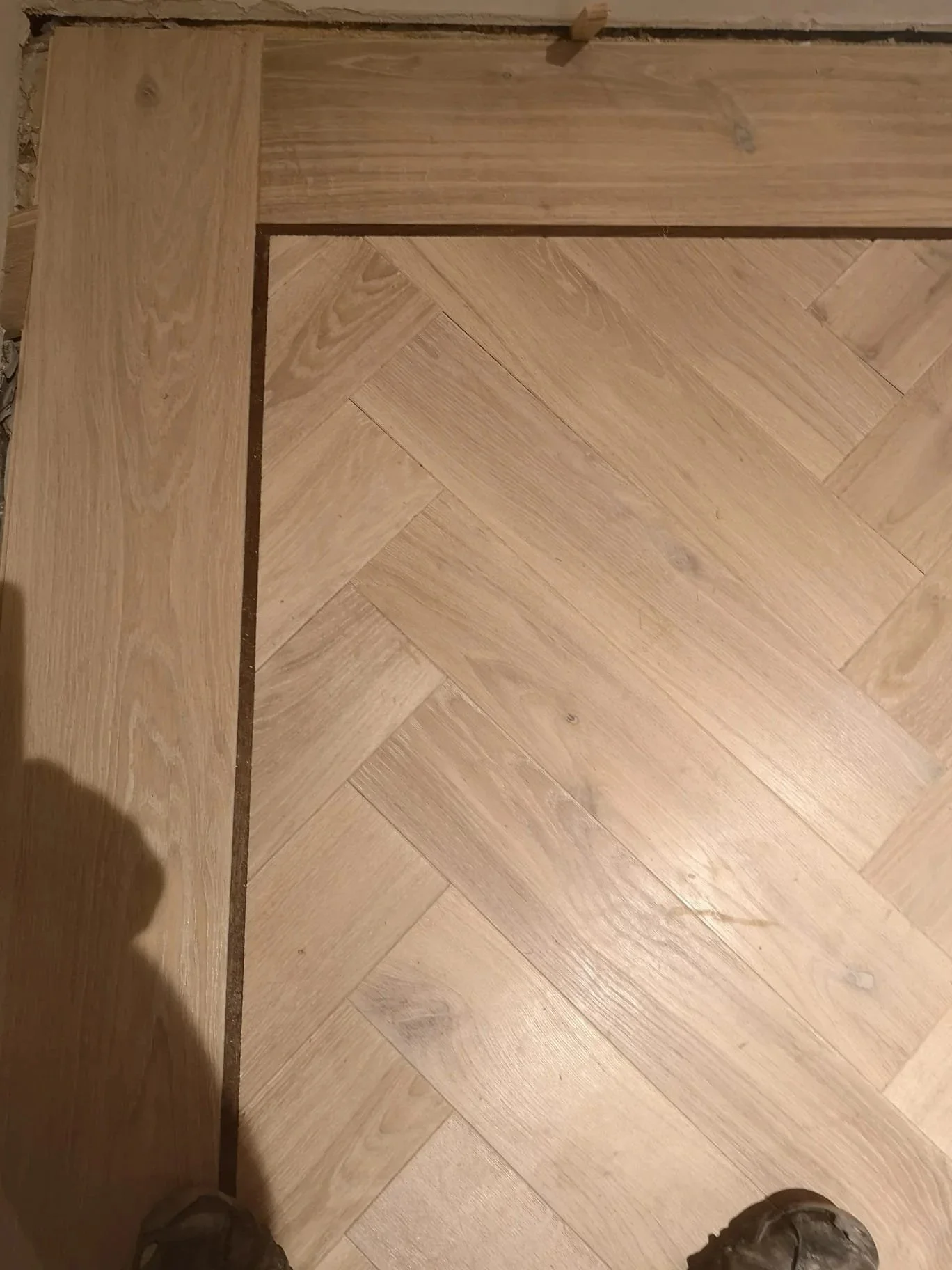 Engineered Herringbone Plank border with walnut inlay