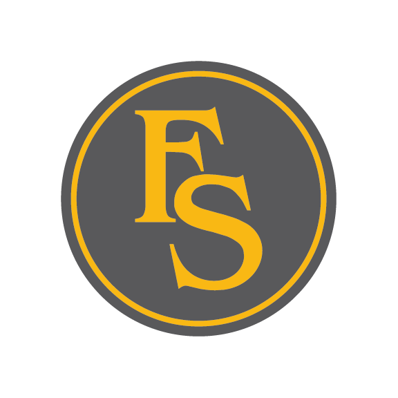 A circular logo with a dark grey background, yellow outline, and yellow letters 'F' and 'S' in the center.