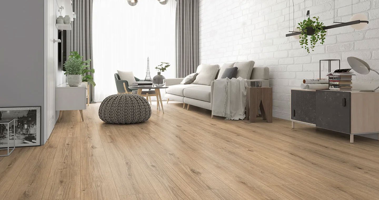 Wall, wooden flooring, white sofa, small side tables, potted plants, hanging ceiling light with greenery, and large window with gray curtains.