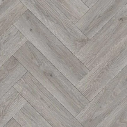 Close-up of light-colored wooden flooring arranged in a herringbone pattern.