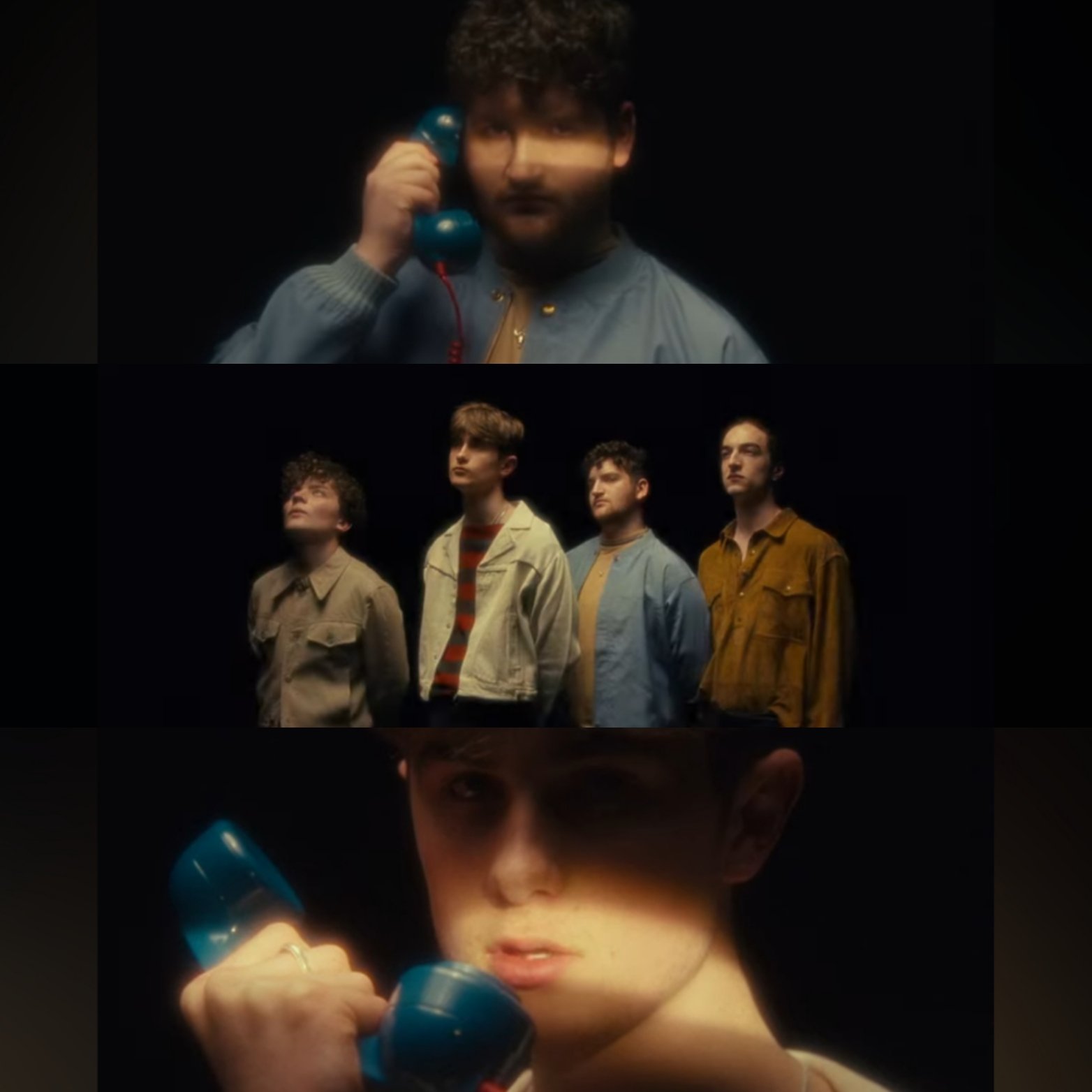 Four young men standing in a dark setting, two of them are holding blue telephones, with one close to his face and the others looking upward, each with distinct expressions.