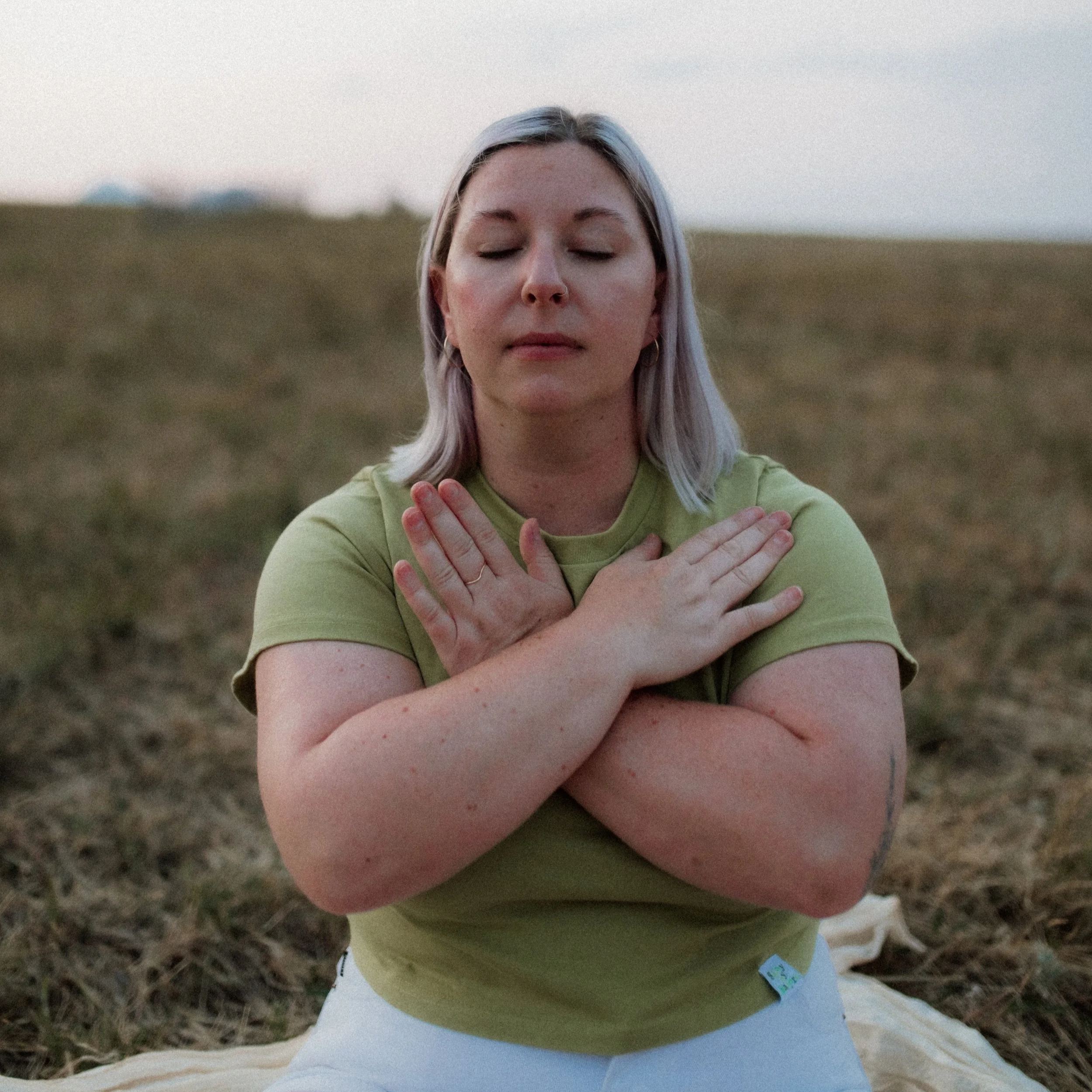 Close-up of a young woman with light hair doing EMDR with butterfly taps