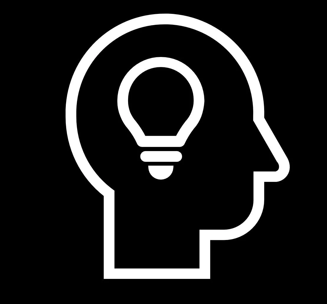 Outline of a head in profile with a lightbulb inside