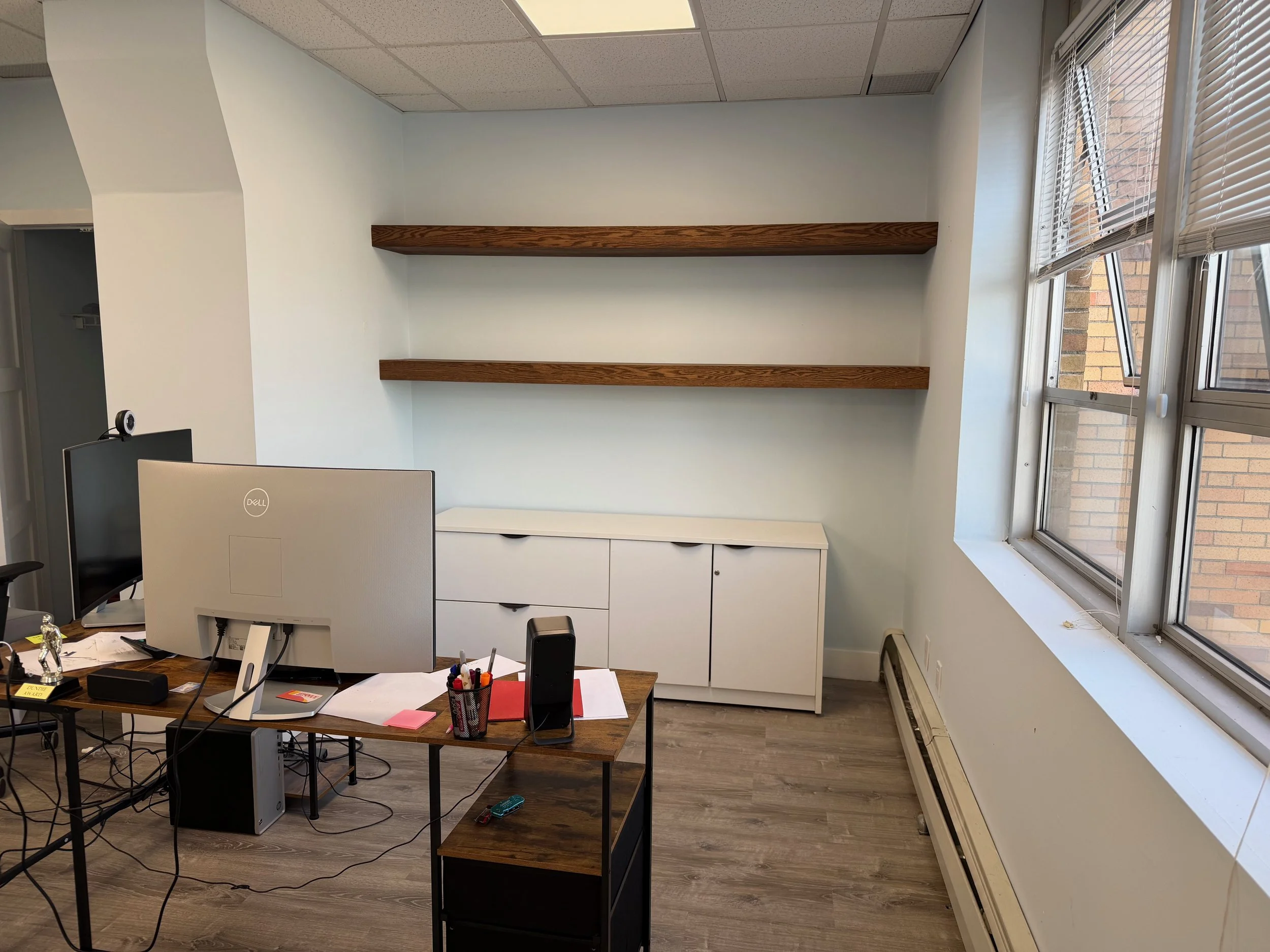 Commercial office needed a little character.  Added floating oak shelves to display owner's memorabilia.