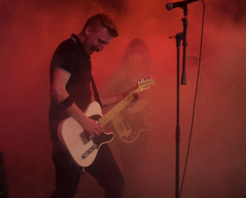 Owner Tyrus Thompson playing a Fender Telecaster guitar
