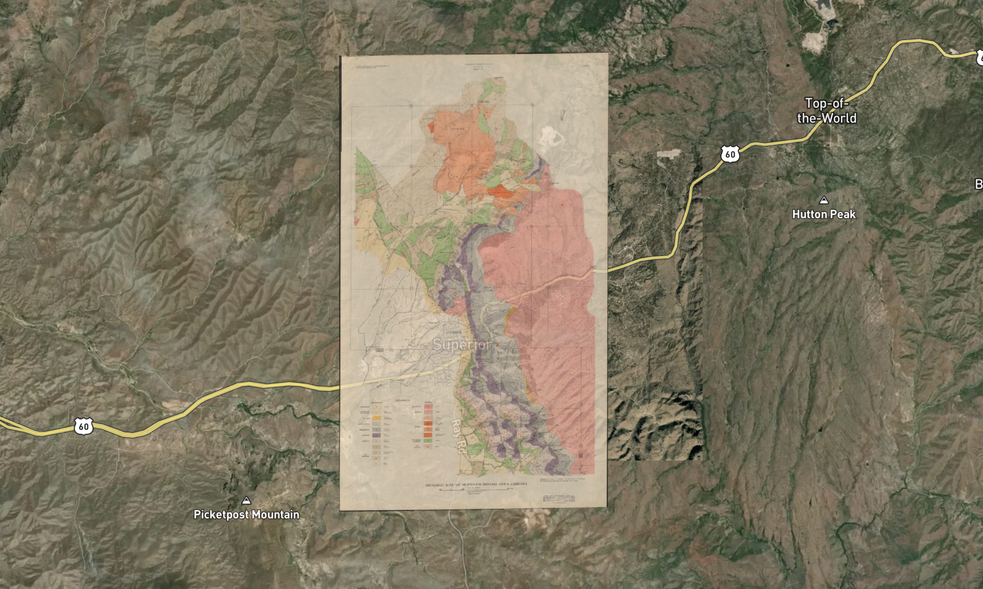 A map superimposed on a satellite image of the Superstition Mountains and surrounding area in Arizona, showing different geological zones in various colors.