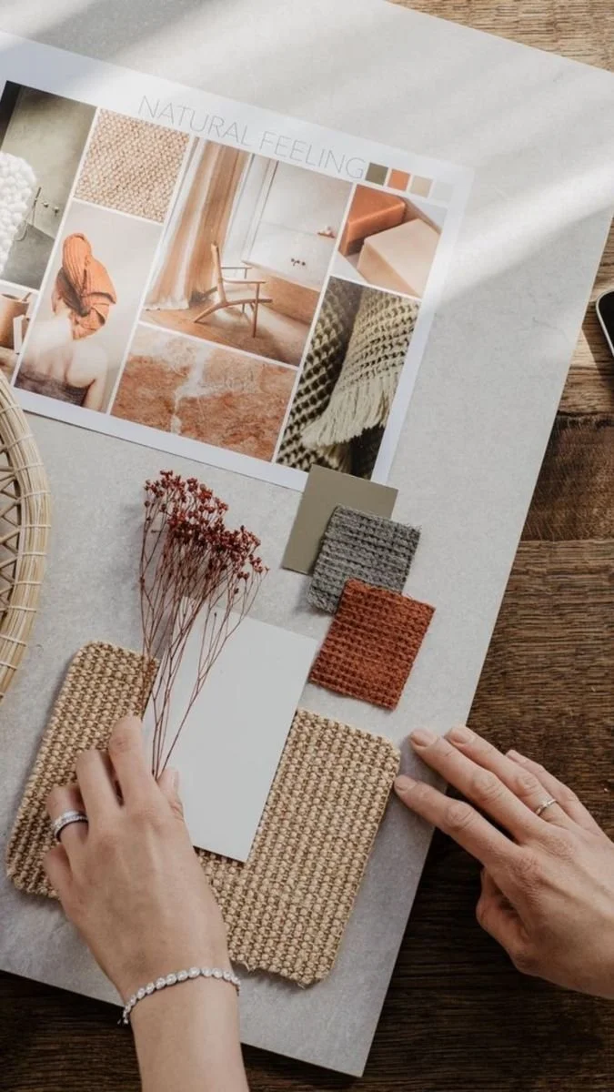 A design mood board titled 'Natural Feeling' features fabric swatches, a color palette, a tissue sample, dried flowers, and photographs of interiors with neutral, earthy tones, textures, and cozy decor.