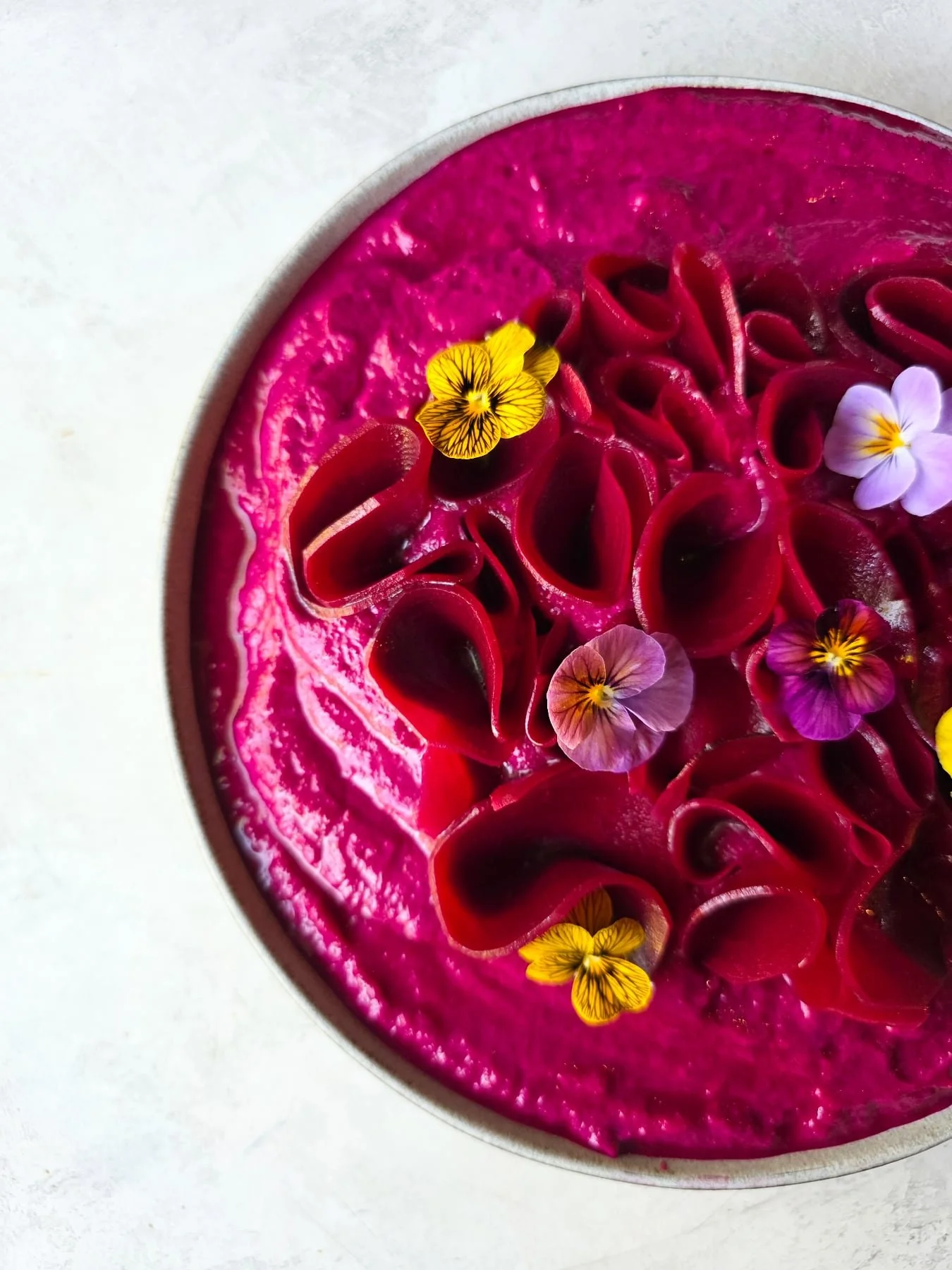 Our seasonal dip:  Beet dip with za&rsquo;atar, yogurt and Fresno chili.

Available for catering AND in our retail case this week
.
.
.
Edible flowers: @wildlyrooted_culinarygarden