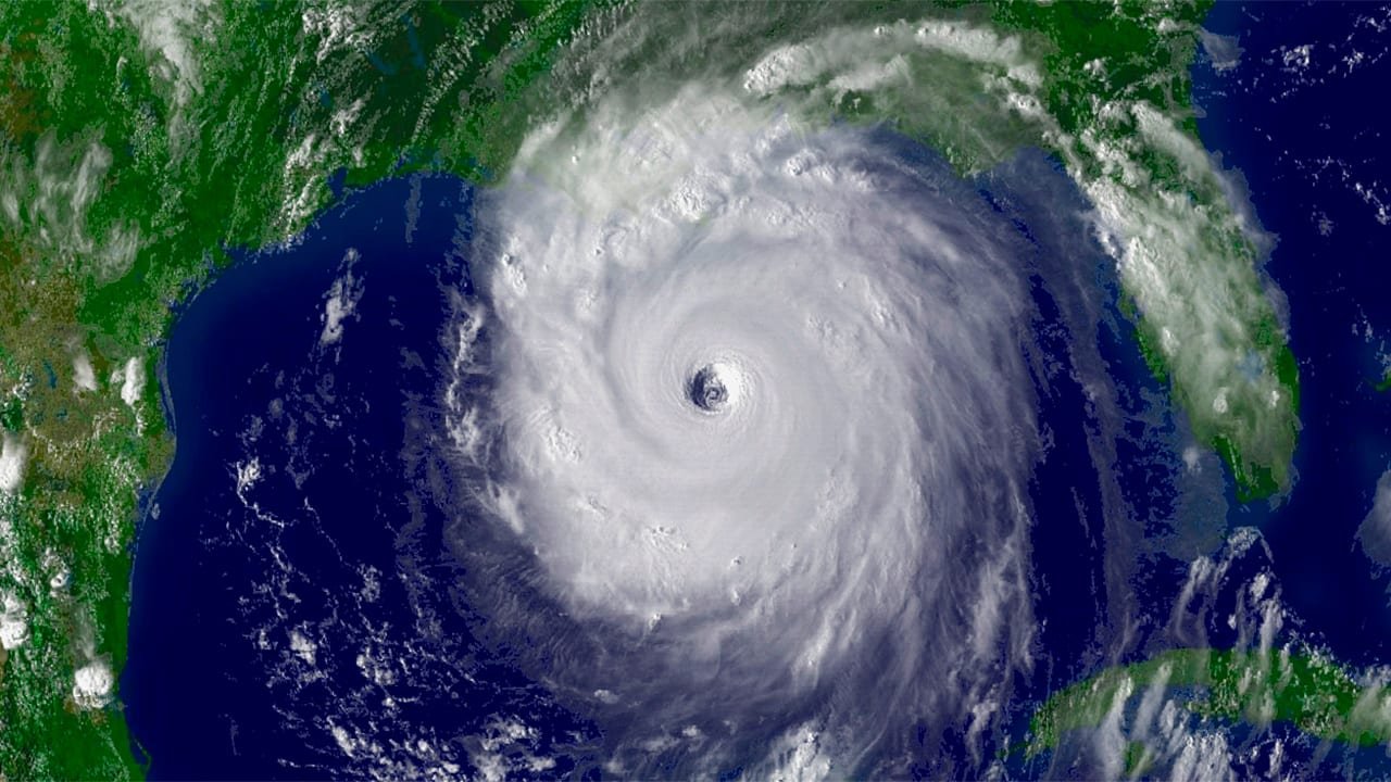 SATELLITE IMAGE OF A HURRICANE OVER THE GULF OF MEXICO WITH LANDMASSES OF FLORIDA AND MEXICO ON THE SIDES