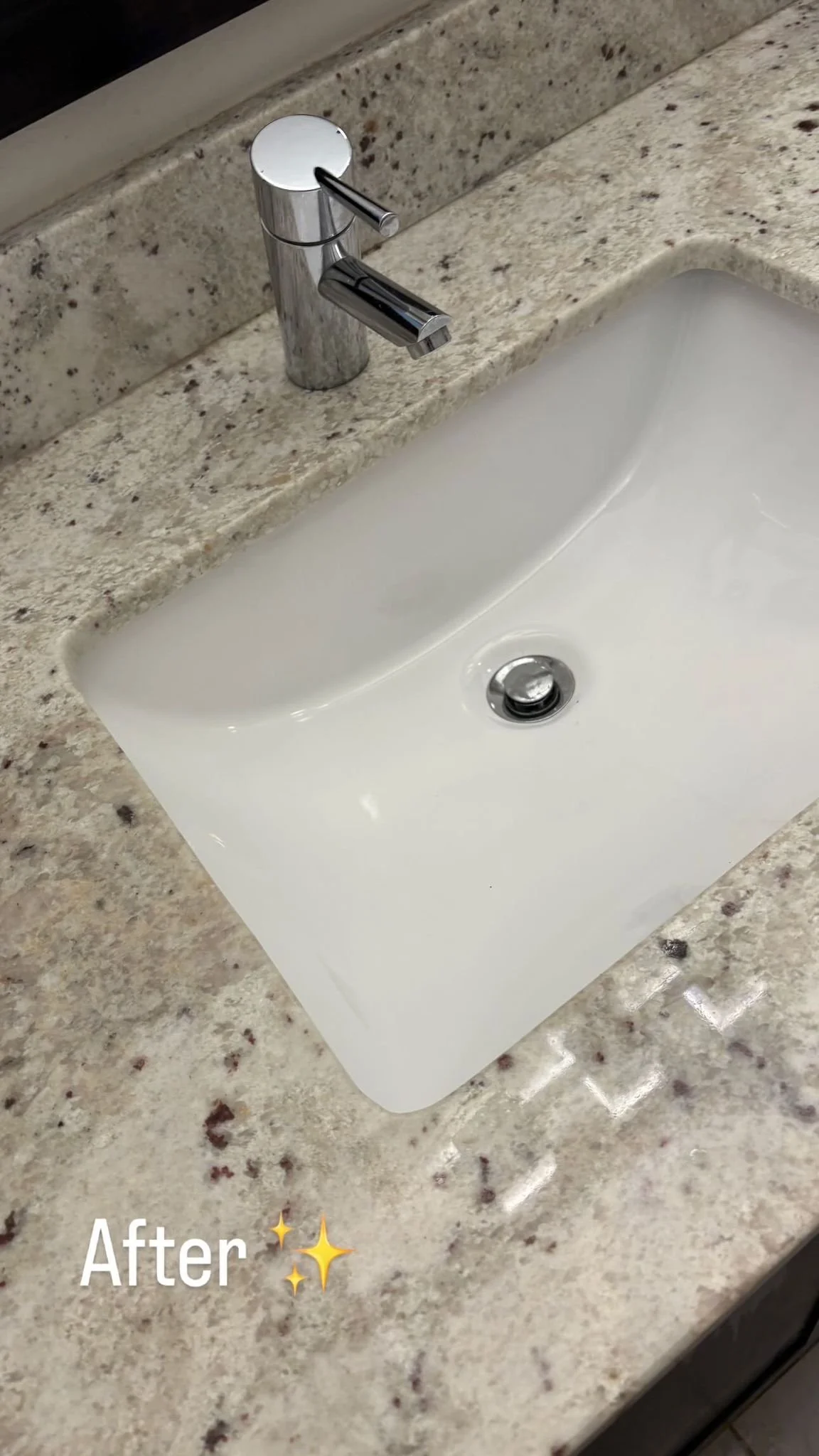 Clean white bathroom sink with a chrome faucet on a speckled granite countertop, labeled 'After' with sparkle emojis.