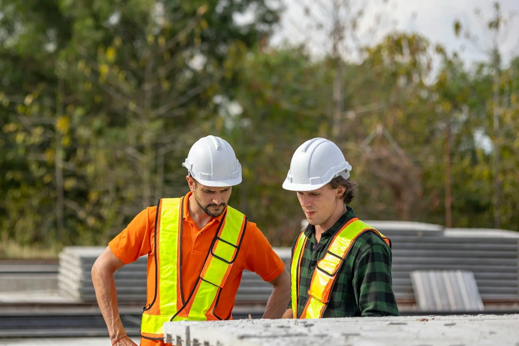 Two construction workers looking at plans.