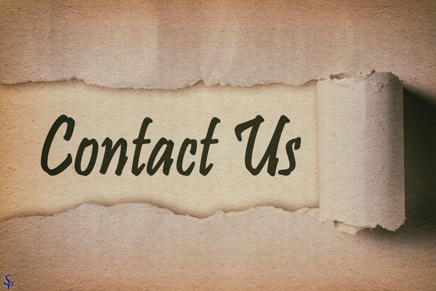 Torn piece of paper with the words 'Contact Us' written on it, pasted on a light brown textured background.
