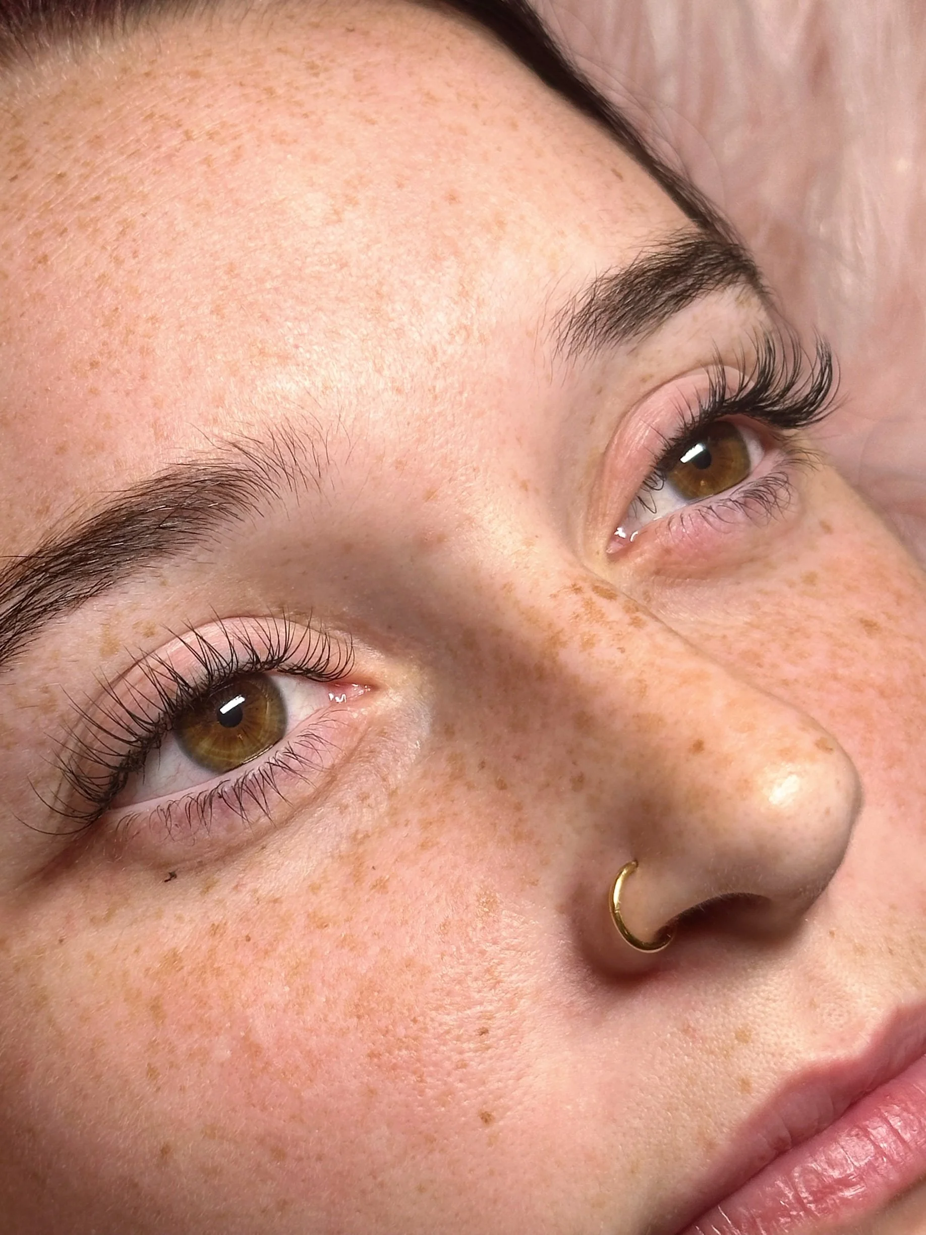 Client after receiving a customized lash extension full set.