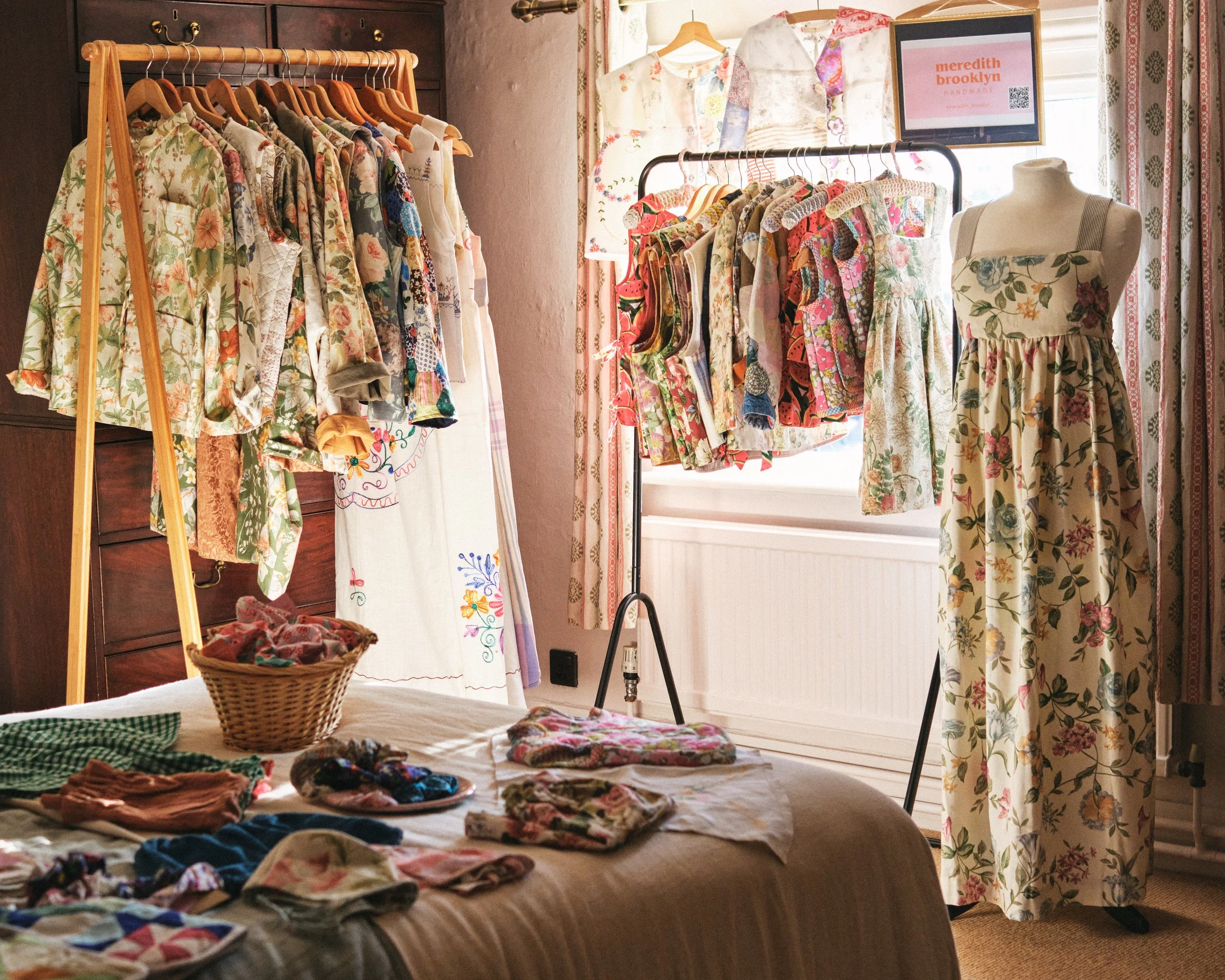 Rails of handmade clothing at a pop up shop