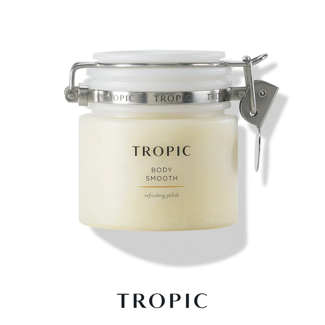 A white jar container with a metal clasp and lid, labeled 'Tropic Body Smooth refreshing polish' against a white background.