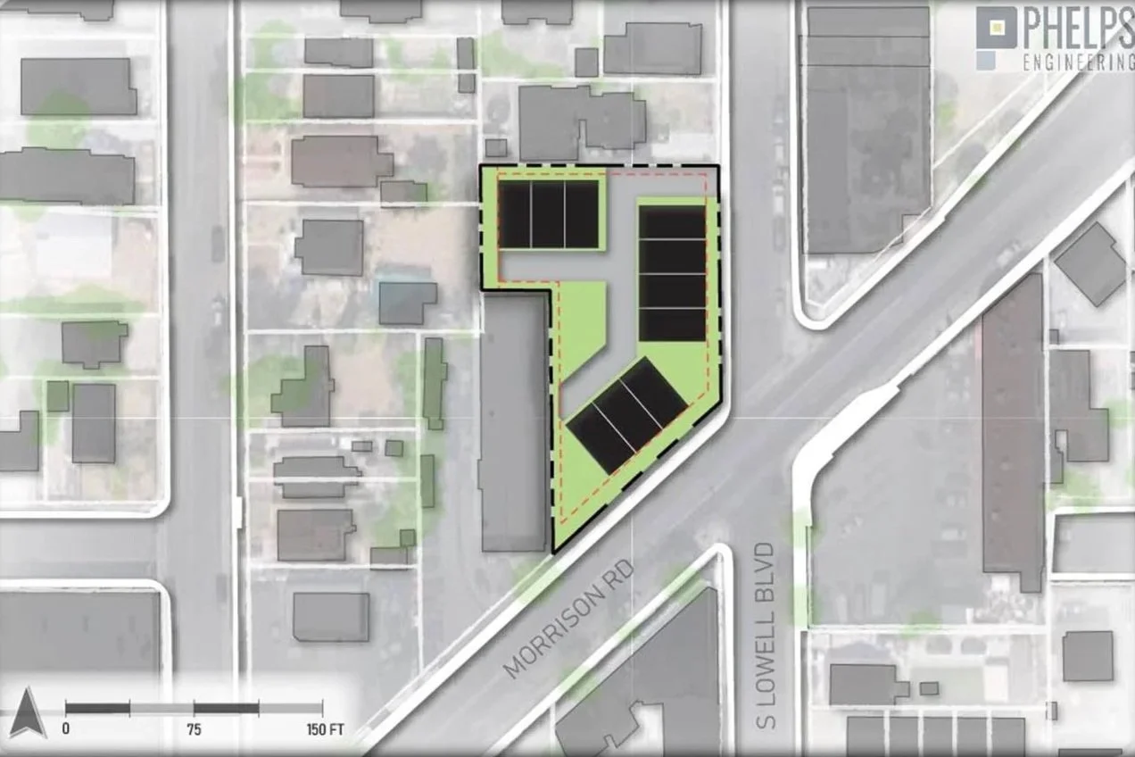 A site plan showing a development with solar panel arrays, a parking lot, and green space, bordered by Morrison Road and South Lowell Boulevard, with surrounding residential buildings.