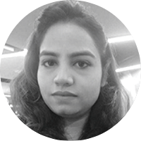 Close-up of a woman with wavy hair looking at the camera, black and white
