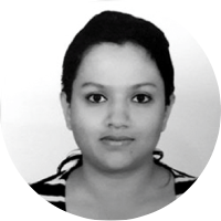 A woman with short dark hair looking at the camera, wearing a striped top, against a plain background.