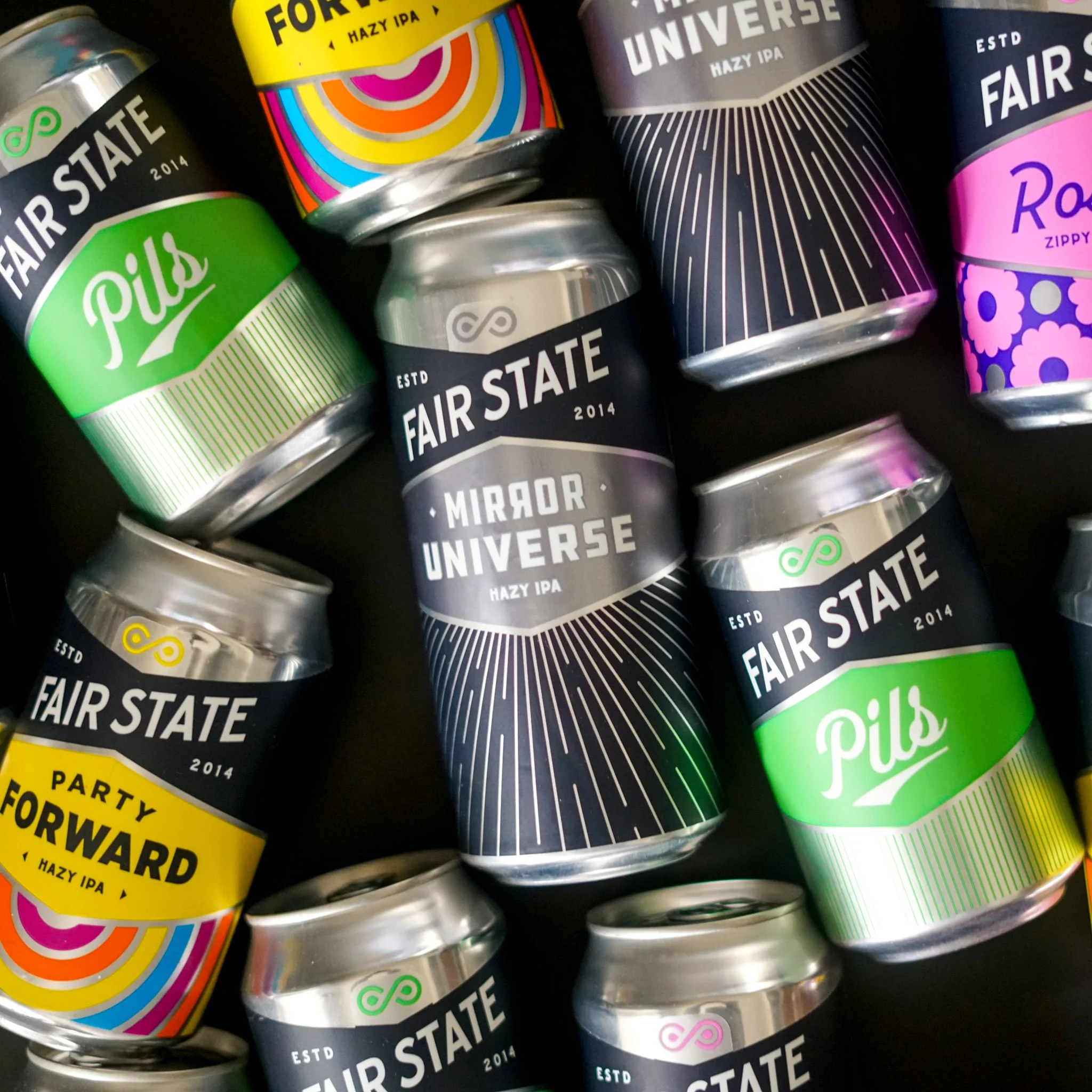 Hand holding a can of water called 'Water Hop' against a clear blue sky.