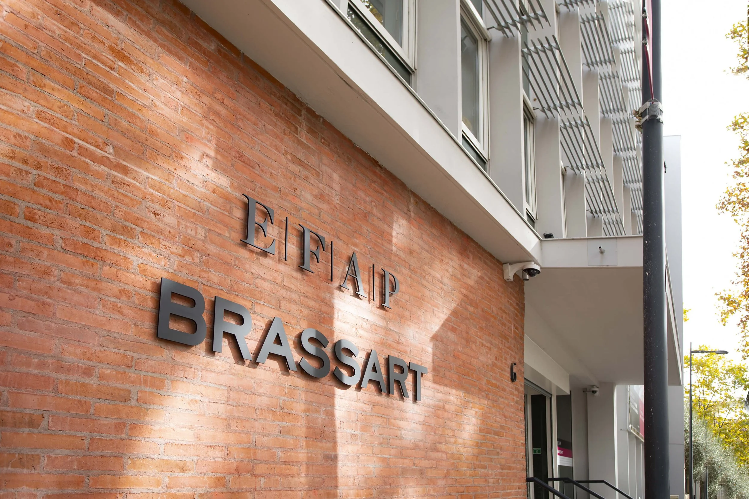 Vue extérieure de l'entreprise Eifai Brassart, mettant en valeur le style architectural moderne et les matériaux de construction.
Détails du style photographique capturant l'enseigne de l'entreprise Eifai Brassart sur un mur en briques.
Décor extérie