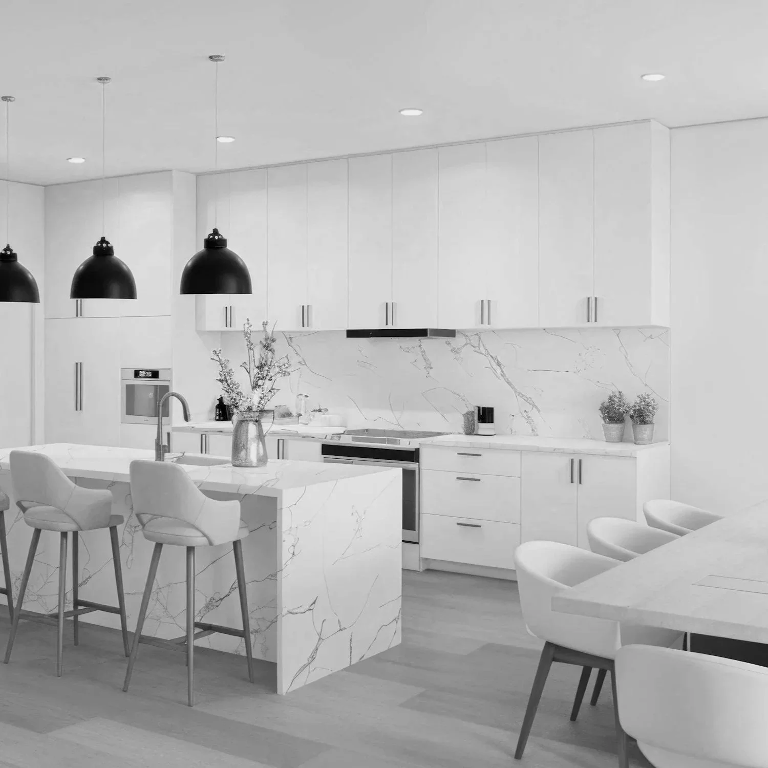 Modern kitchen with white marble countertops, white cabinets, black pendant lights, and a breakfast bar with four chairs.