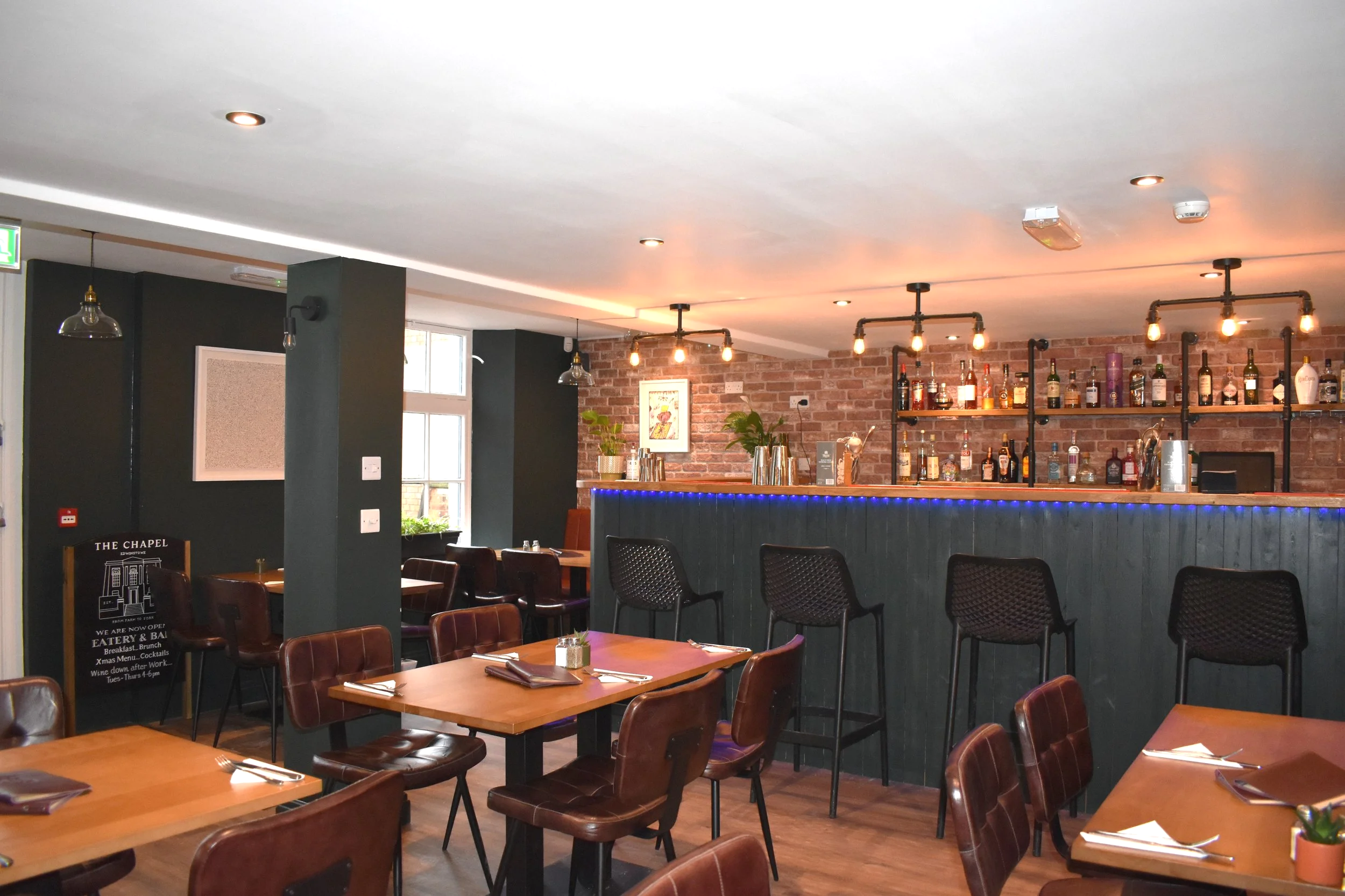 Dark decor, light ceiling, industrial feel, exposed brickwork.