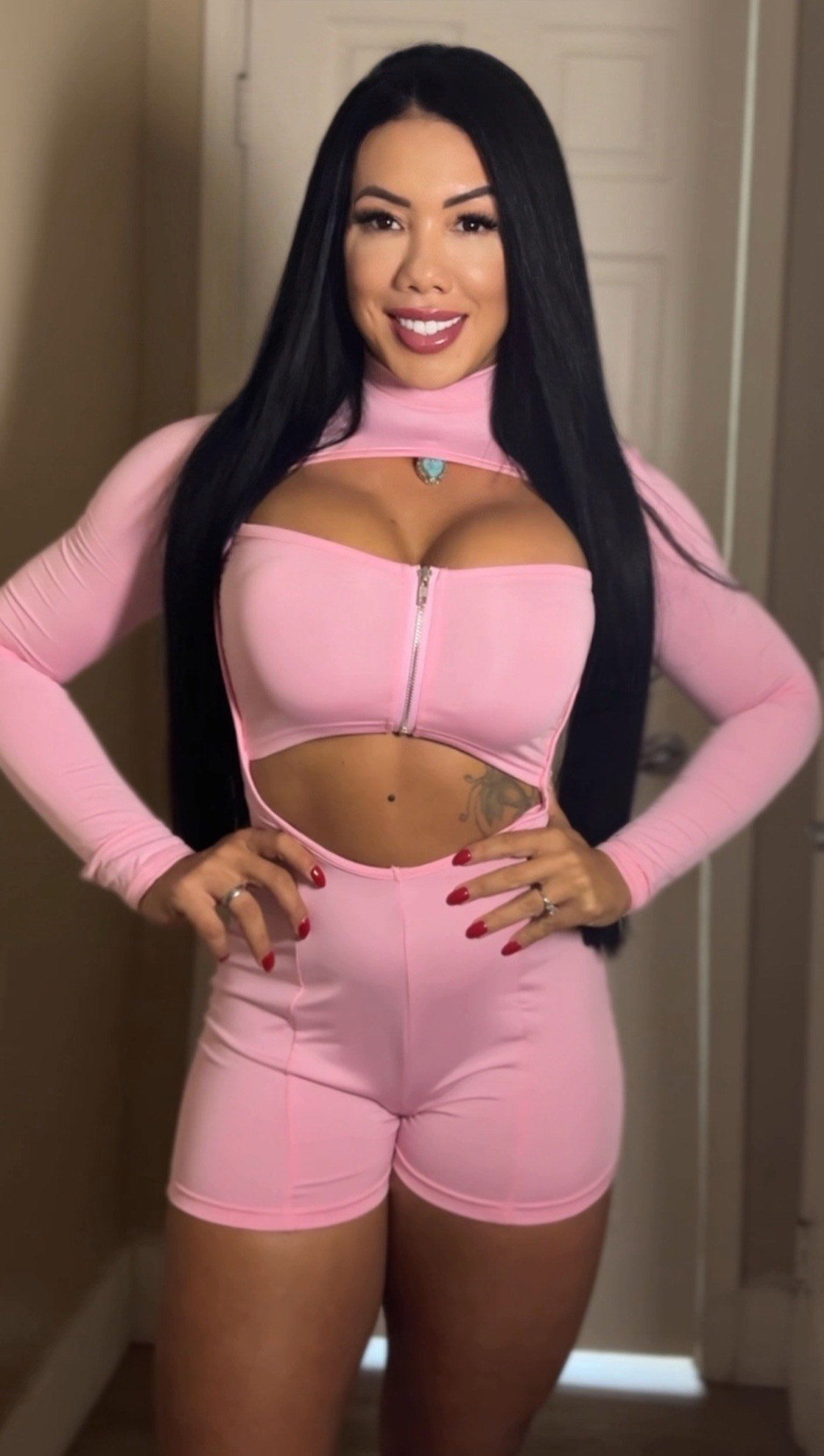 Confident athletic woman wearing pink sculpting jumpsuit from Copa Closet luxury activewear brand, designed for strong women who train hard and want performance, compression and sexy confidence.jpeg