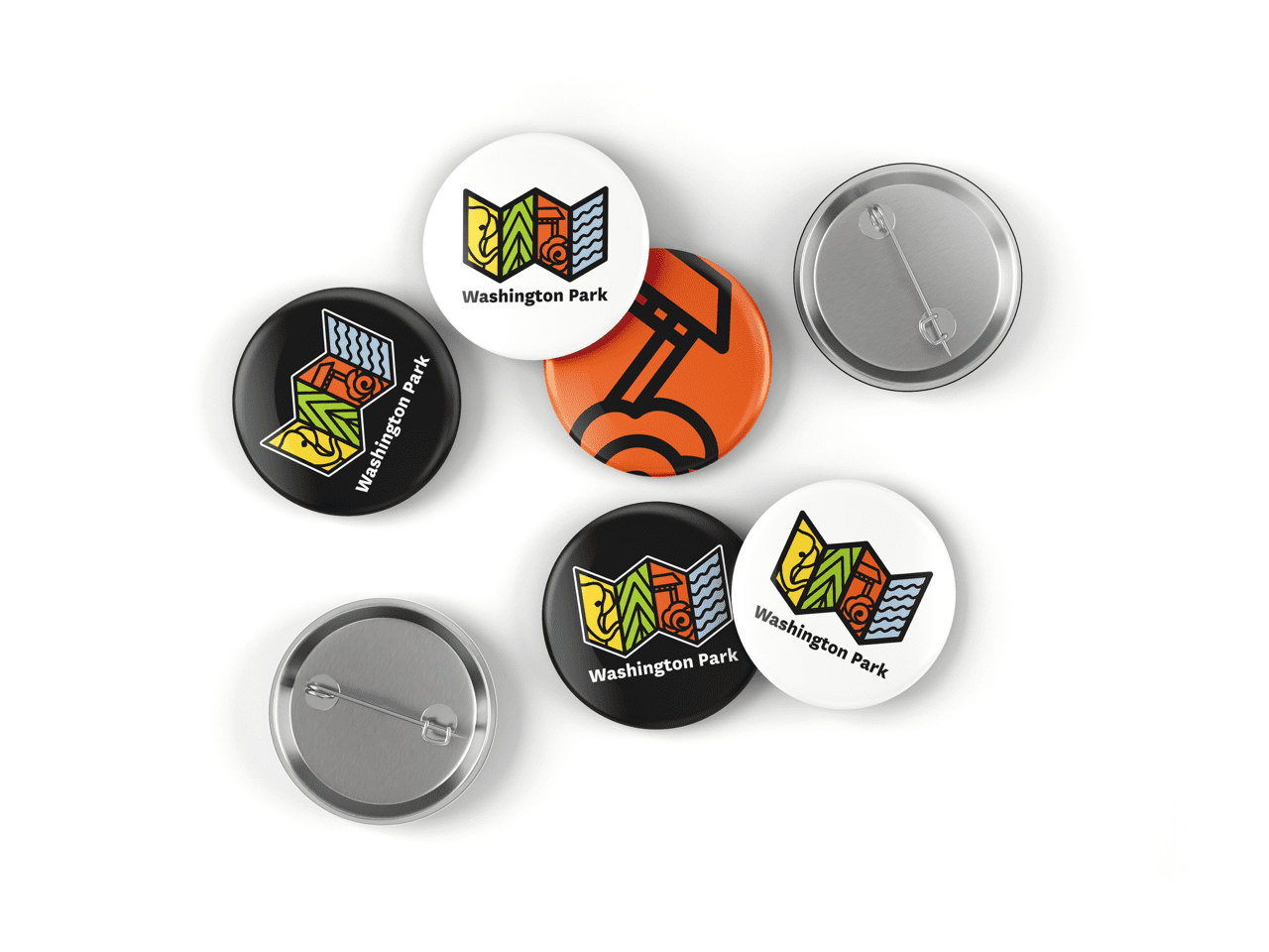 Several circular Washington Park pin buttons in different styles, including a white pin with the colorful logo, a black pin, and an orange pin