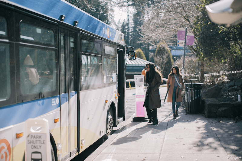 Two women boarding a TriMet Line 63 bus near Washington Park in winter