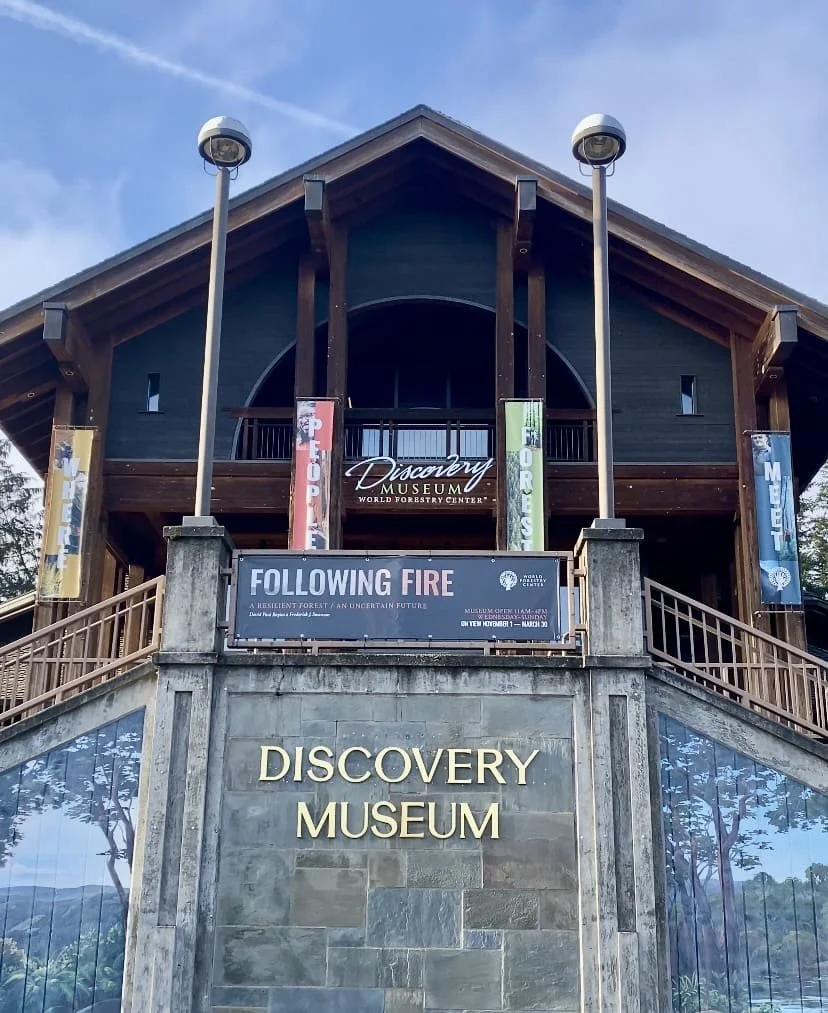 The entrance to the World Forestry Center’s Discovery Museum, with banners for the “Following Fire” art exhibit.