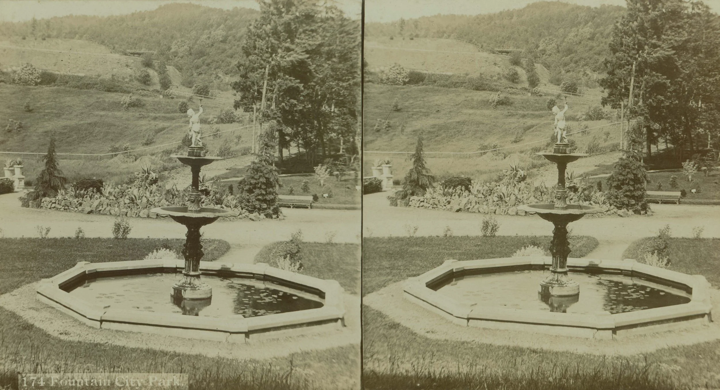 Chiming Fountain (A2004-002.6702) - Stereoview historical photo of an ornate tiered fountain in a stone basin set in a manicured garden, with a wooded hillside in the background