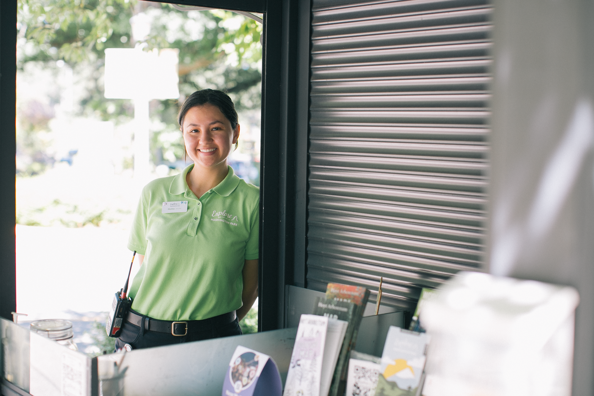 A Washington Park visitor services staff member assisting a guest.
