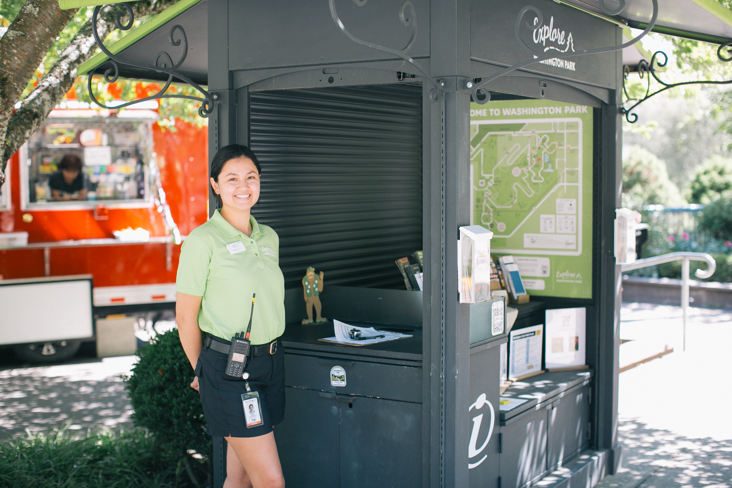 The Washington Park visitor information booth, next to its hours and locations.