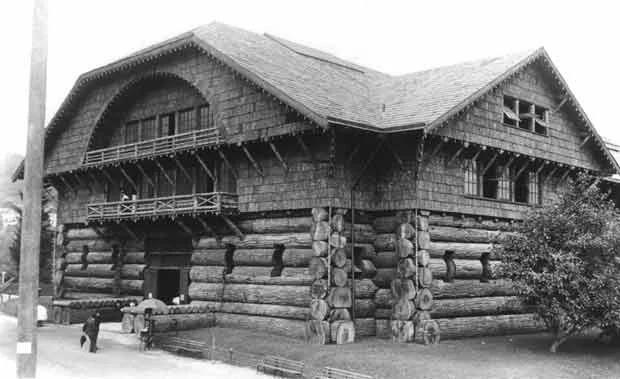 Historic black-and-white photograph of the World Forestry Center's original giant log cabin building