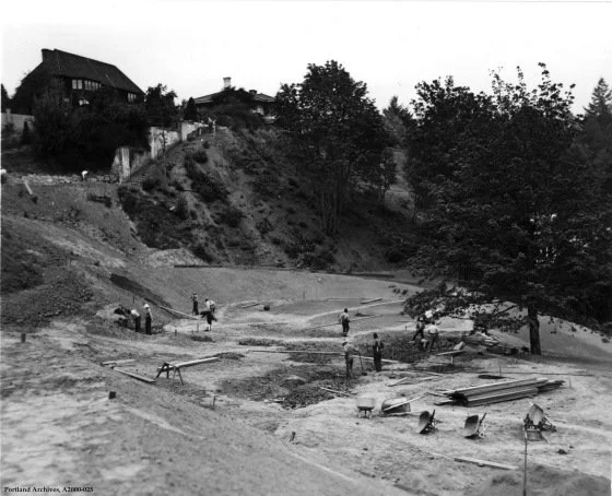 Public Works Relief Projects, Washington Park NE - Black-and-white photo of workers grading and constructing on a steep hillside in Washington Park, with a large craftsman-style house visible above