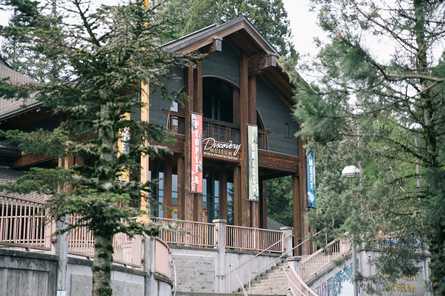 Exterior of the World Forestry Center Discovery Museum building with signage and seasonal banners