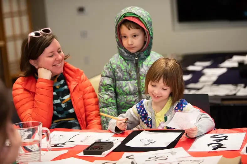 Visitors try Sumi-e ink-wash painting at the O-Shogatsu New Year celebration.