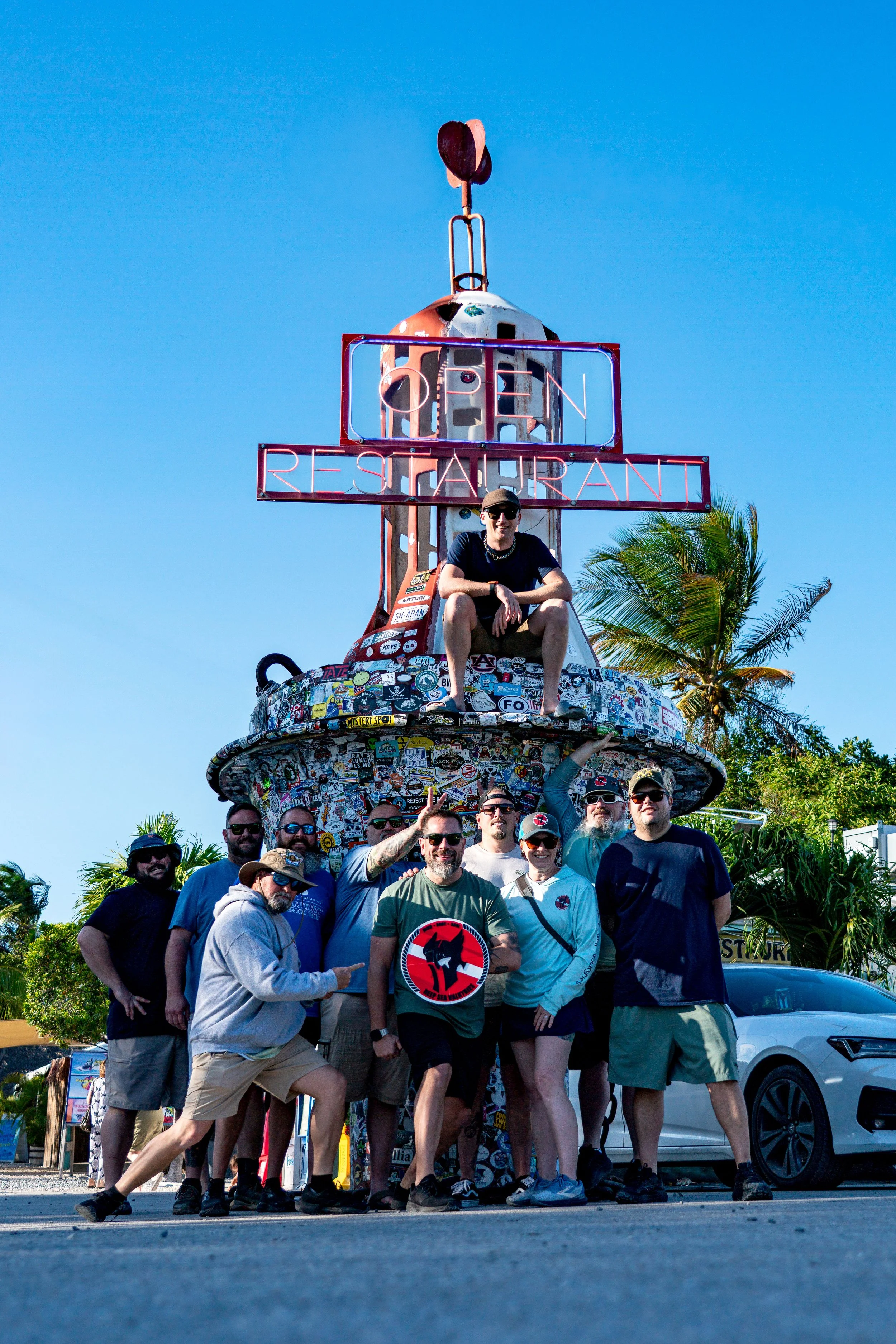 Group of 10 men and 1 woman holding a shield with Deep Sea Valkyries logo