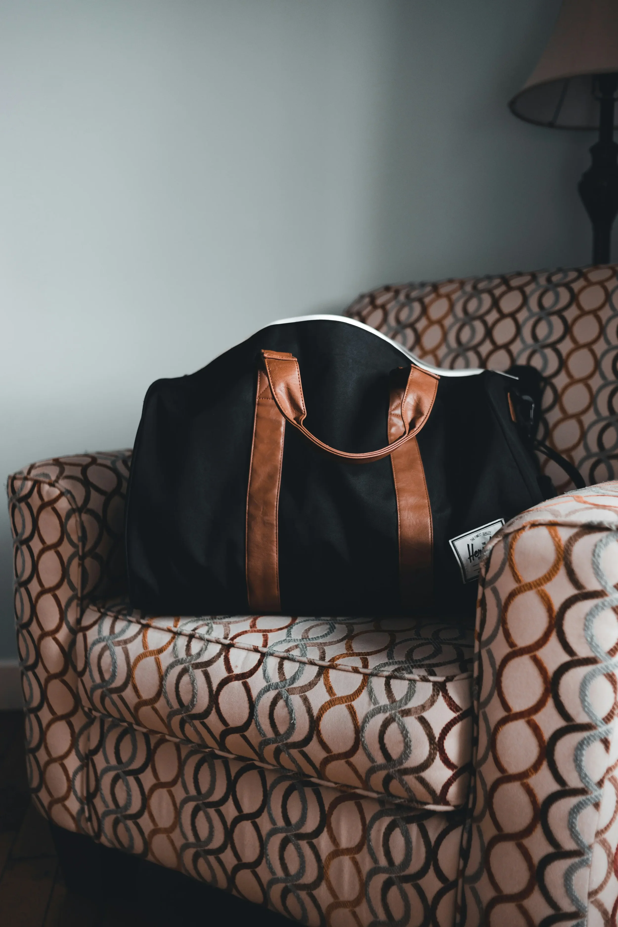 Packed weekend bag sitting on a chair, waiting to go