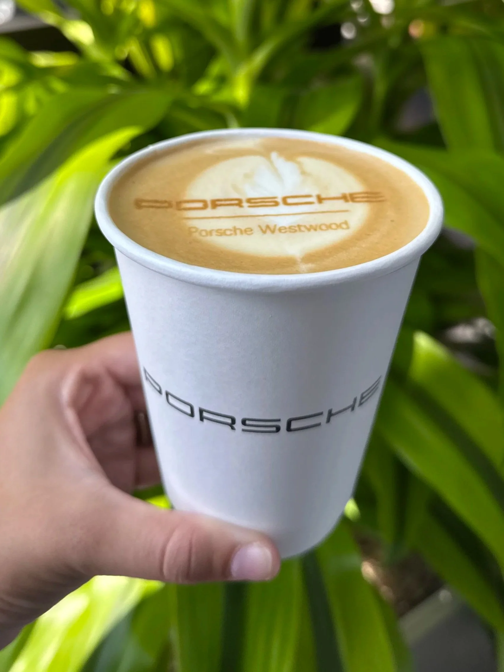 Custom latte art with Porsche logo for car reveal event catering in Westwood, MA