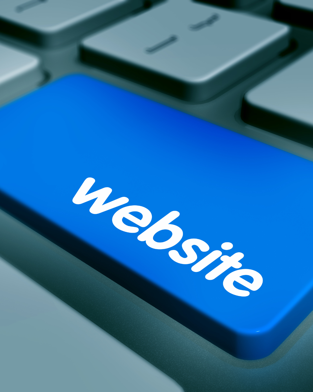 Close-up of a computer keyboard with a blue screen displaying the word 'website' in white text.