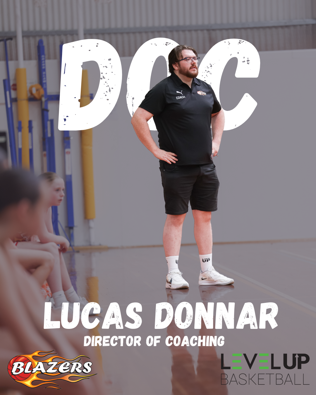Basketball coach Lucas Donnar standing on the sideline during training or game, with young players seated in the foreground, gymnasium setting with sports equipment in the background, and overlay text including his name, position, and team sponsorship logos.