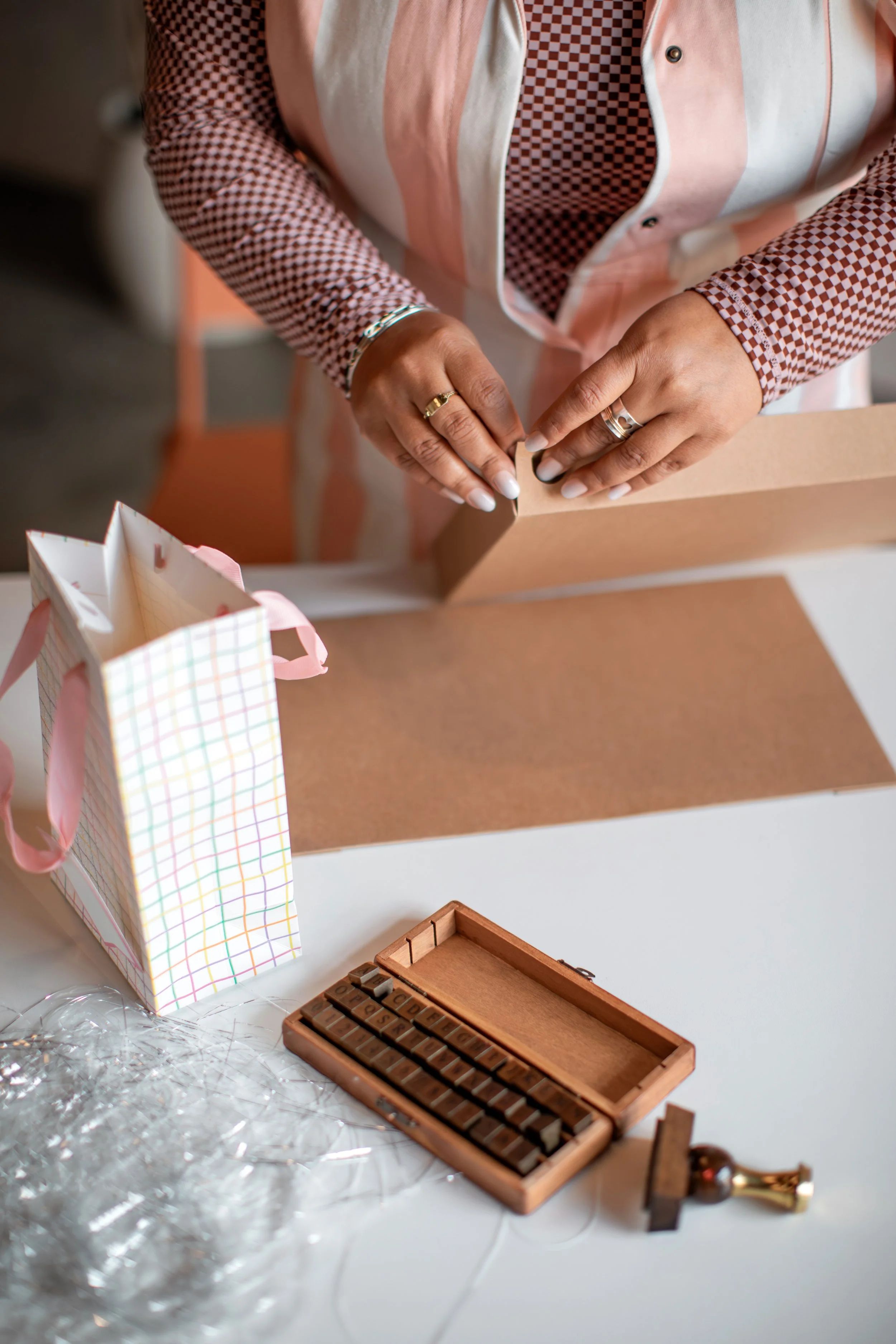 A person holding a 2026 calendar, with a white cover featuring the year and the word 'calendar' in large text.