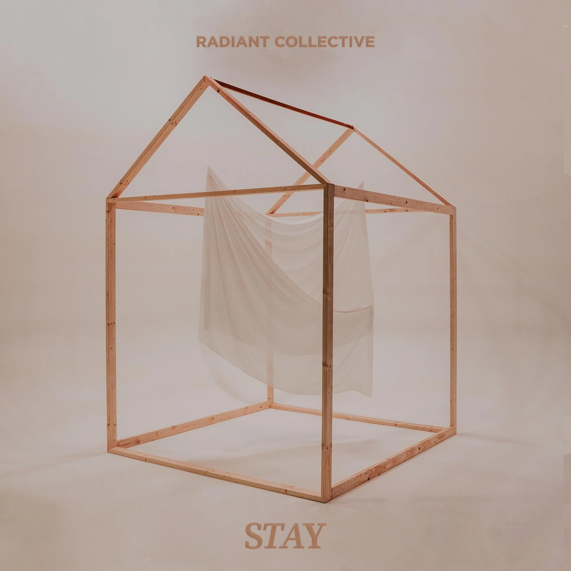 A minimalist wooden house frame with a hanging fabric inside, labeled 'Radiant Collective' at the top and 'Stay' at the bottom.