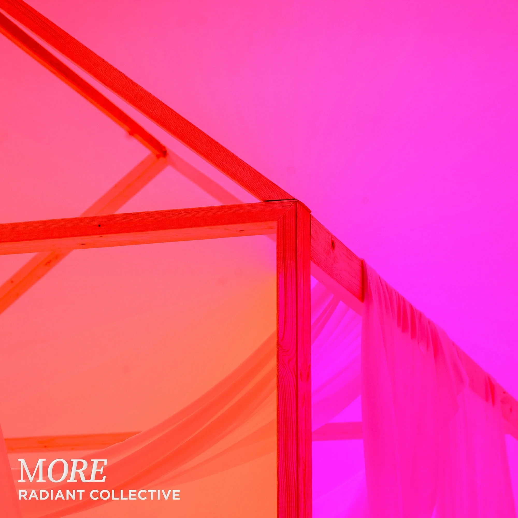 Close-up of a colorful, geometric structure with wooden frames and draped fabric, illuminated by pink and purple lighting, with the text 'MORE RADIANT COLLECTIVE' in the bottom left corner.