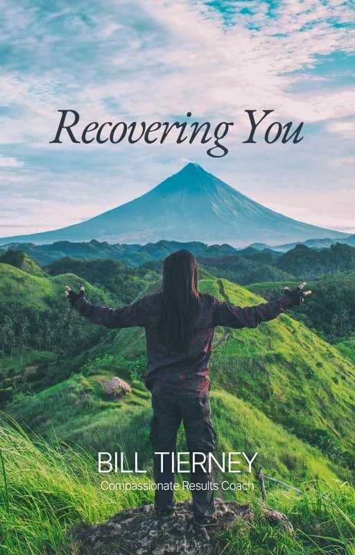 A woman stands on a grassy hill with arms outstretched, overlooking a lush green landscape and a mountain in the distance, with the text 'Recovering You' and 'Bill Tierney, Compassionate Results Coach'.